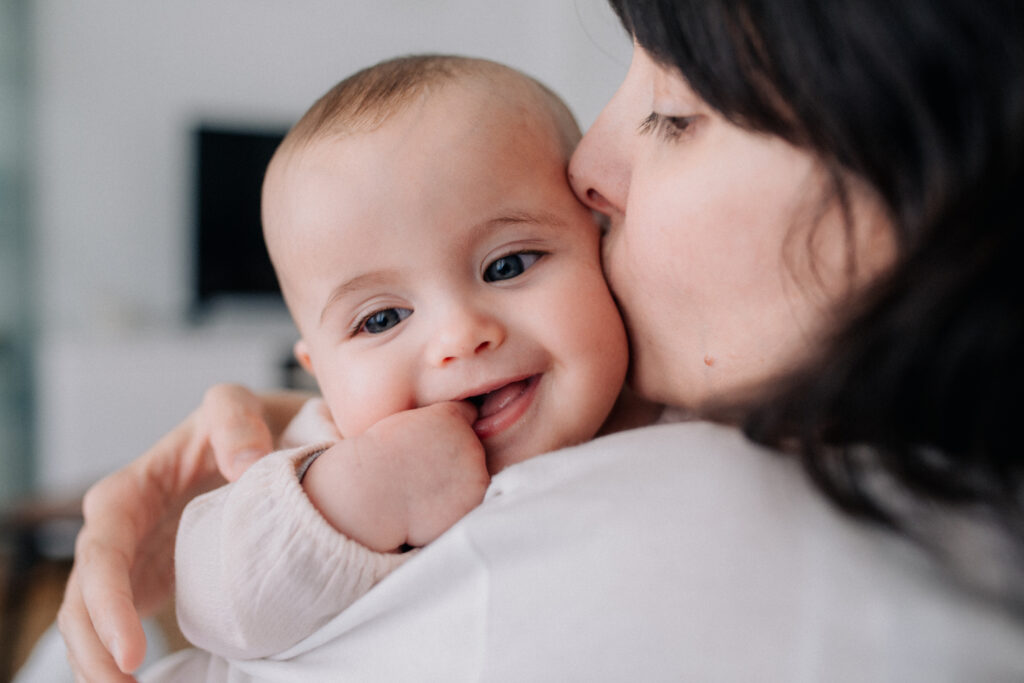 Mother cuddling with her baby daughter