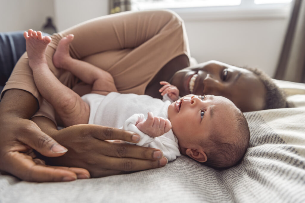 A Portrait of a beautiful black mother, with her nursing baby
